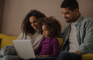 Parents and child using a laptop